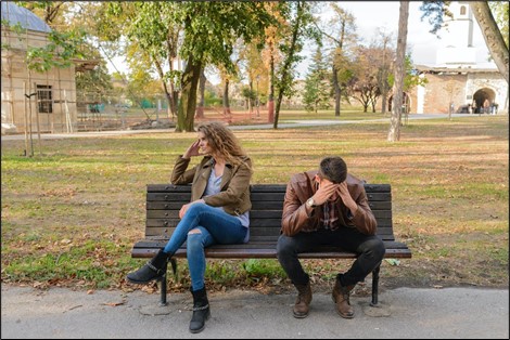 Upset Couple Sitting on a Bench 